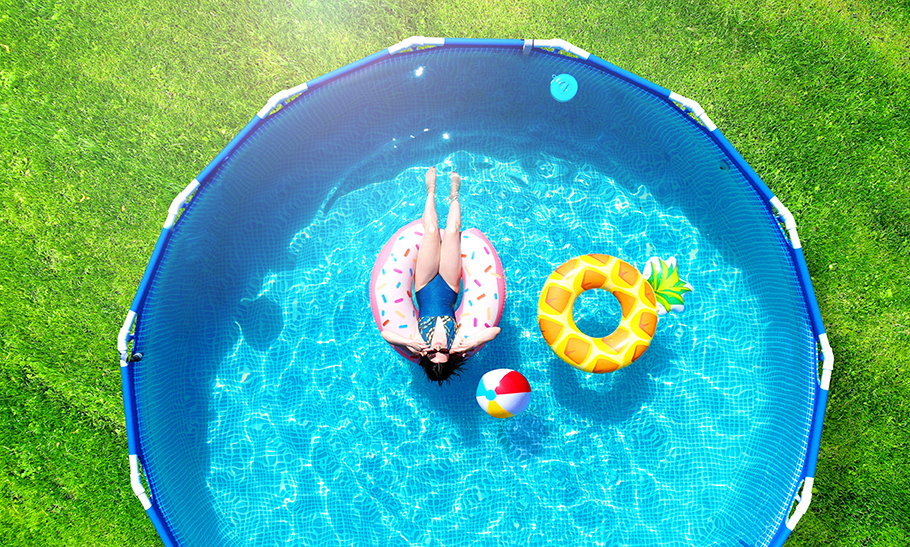 Woman Relaxing in Above Ground Pool, birds eye view.
